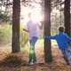 A Teenager Plays with a Child Runs in the Park Around a Tree and Catches Up with Him - VideoHive Item for Sale