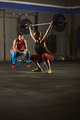 Woman squatting and lifting a barbell. - PhotoDune Item for Sale