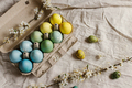 Stylish easter eggs and blooming cherry branch on rustic table. Happy Easter! Rustic easter flat lay - PhotoDune Item for Sale