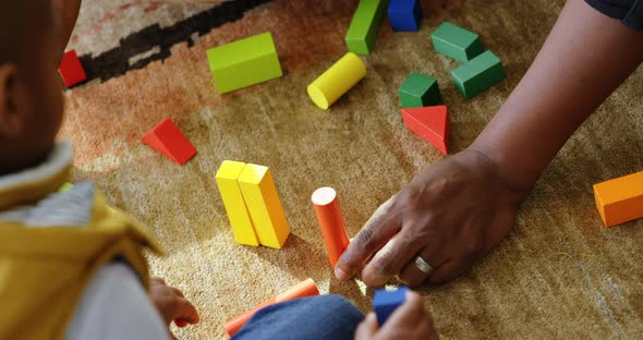 Father and son playing with building blocks in a comfortable home 4k