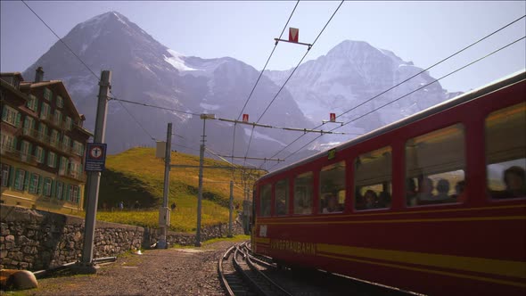Swiss railcar full of passengers passes hotel