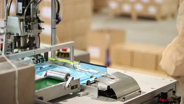 Industrial Production of Medical Masks - Putting Masks on the Bend and Attaching Ear Loops To Them