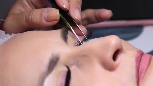 in a Beauty Salon a Woman Undergoes an Eyelash Extension Procedure