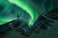 Northern lights and young woman on mountain peak at night. Auror - PhotoDune Item for Sale