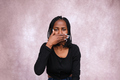 Frontal view of afro woman covering her mouth with one hand. - PhotoDune Item for Sale