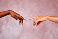 Caucasian man's hand approaching afro woman's hand. - PhotoDune Item for Sale