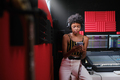 Afro and looking at her cell phone in the recording studio. - PhotoDune Item for Sale