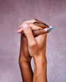 Close-up of Afro woman's hand with blue nails intertwined with Caucasian man's hands. - PhotoDune Item for Sale