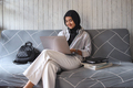 Muslim woman using laptop at home - PhotoDune Item for Sale