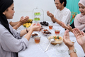Muslim people praying before break fasting iftar dinner together - PhotoDune Item for Sale
