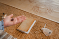 There is a dice in a person's hand. Close-up of a hand with a dice on the background of a notebook - PhotoDune Item for Sale