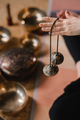 Close-up of a woman's hand holding Tibetan bells for sound therapy. Tibetan cymbals - PhotoDune Item for Sale