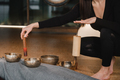 Close-up of the hands of a young woman transmitting a message with the help of singing bowls and  - PhotoDune Item for Sale