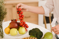 close-up of vegetables, fruits on the kitchen table. cooking.The hostess holds small tomatoes - PhotoDune Item for Sale