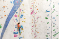 Young Woman rock climbing indoors. - PhotoDune Item for Sale