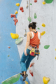 Young Woman rock climbing indoors. - PhotoDune Item for Sale