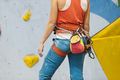 Woman getting ready for rock climb indoors. - PhotoDune Item for Sale
