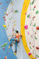Young Woman rock climbing indoors. - PhotoDune Item for Sale