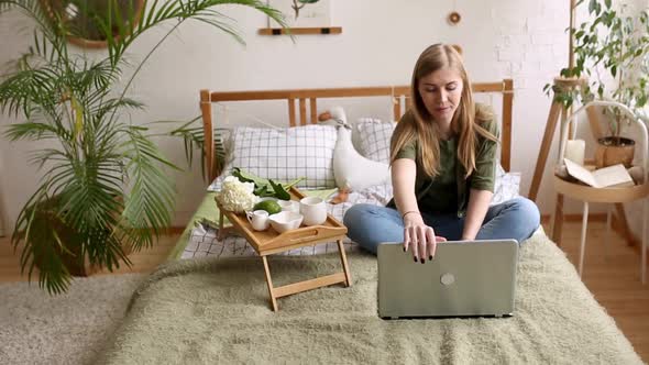 A Young Freelance Woman Who Has a Video Call with a Colleague Working Online From Home in a Cozy