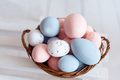 Easter eggs in the woven basket isolated on white background . Pastel color Easter eggs - PhotoDune Item for Sale