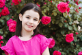Cute smiling kid girl with rose flowers in park outdoor - PhotoDune Item for Sale