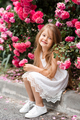 Cute laughing kid girl with rose flowers in park outdoor - PhotoDune Item for Sale