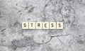 Stress word tiles on a cracked concrete background - PhotoDune Item for Sale