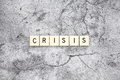 Crisis word tiles on a cracked concrete background - PhotoDune Item for Sale