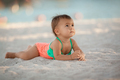 Infant baby girl relaxing on sandy beach at summer vacation - PhotoDune Item for Sale
