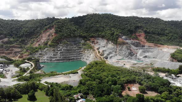 Aerial view of opencast mining quarry with big pool. Aerial view from drone shoot