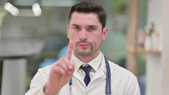 Young Male Doctor Saying No with Finger Sign 