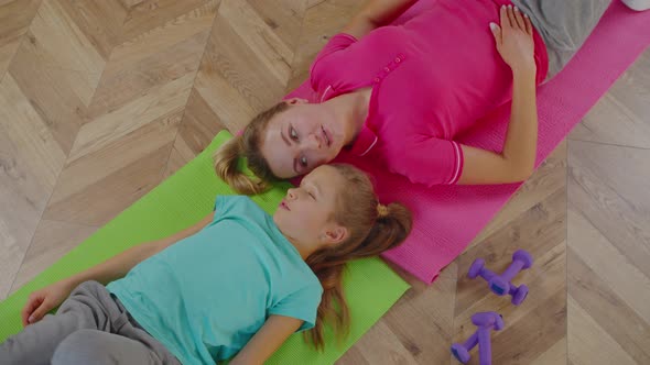 Overhead Portrait of Mom with Girl Relaxing After Training