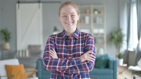 Young Woman Standing With Arms Crossed And Smiling