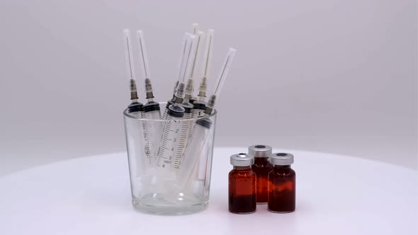 Vaccine bottle with red solution with syringe