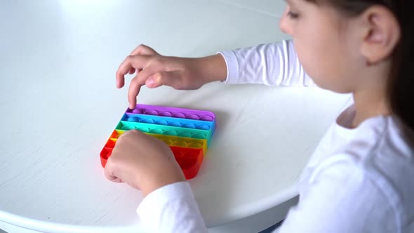 Baby Girl Playing with Rainbow Pop It Fidget