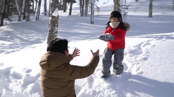 Asian Father And Son Playing In The Park On Winter Day 