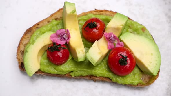 Top View of Fresh Avocado Toast with Grilled Cherry Tomatoes
