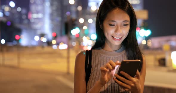 Woman use of mobile phone at night 