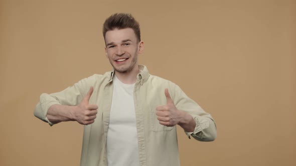 Portrait of Stylish Guy Showing Thumbs Up Gesture Like and Smiling