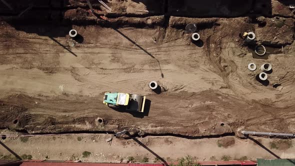 Aerial Construction Site with Machinery, Bulldozer, Excavation.