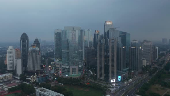 Aerial Truck View Circling Around a Building Complex of Multiple Skyscrapers in Modern City Center