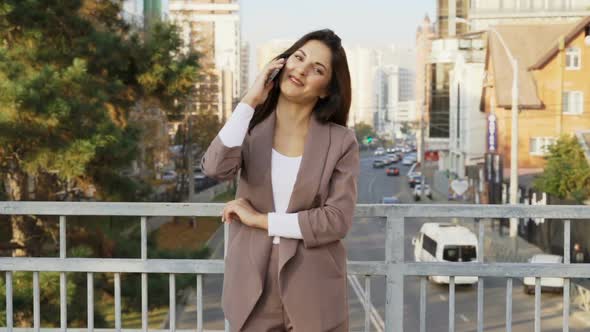 Beautiful Brunette Businesswoman In Business Clothes Walks In The City