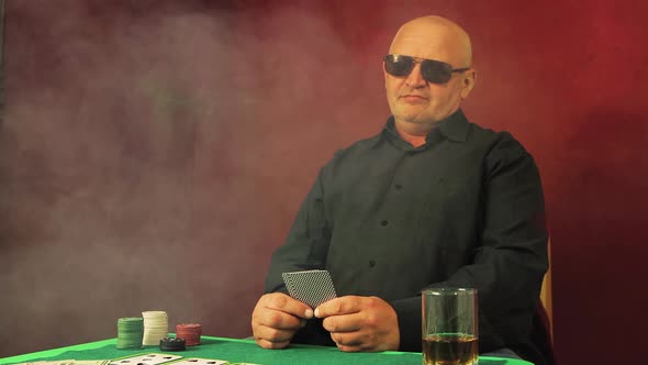 The Risky Poker Player Sits at the Green Table and Ponders the Bet