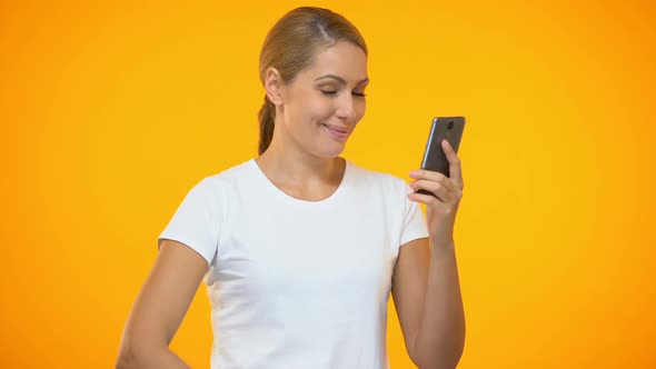 Smiling Young Woman Showing Ok Gesture Holding Smartphone in Hand, Cash Back