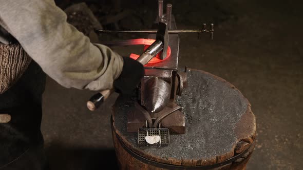 Smith Bending Metal with a Hammer and a Anvil