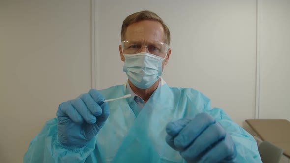 Male Healthcare Worker in PPE Taking Patient Swab Sample for PCR Test for Coronavirus at Hospital