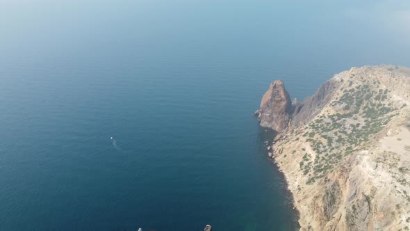 Aerial View From Above on Calm Azure Sea and Volcanic Rocky Shores