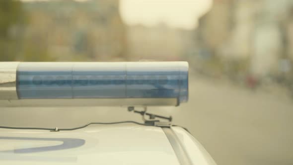 Flashing Flasher on the Roof of a Police Car. Blinker. Close-up.