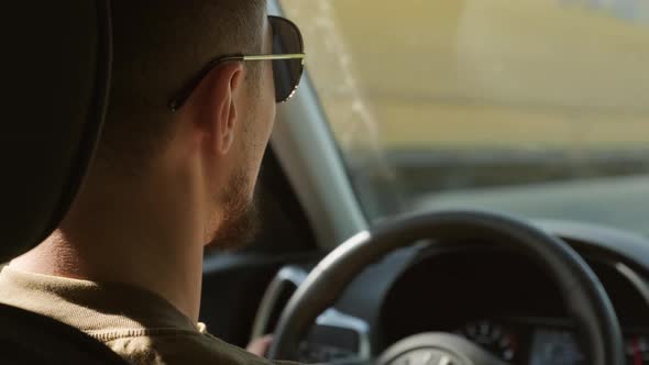 Man Driving Car And Talking