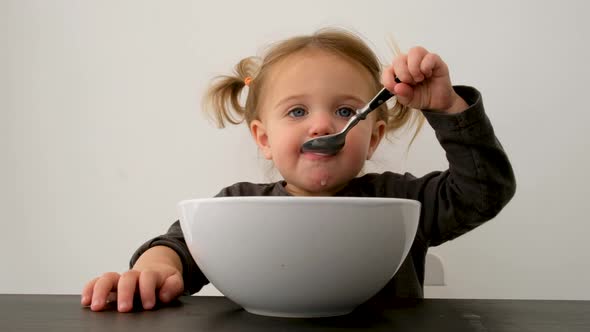 Cute Small Girl Having Yummy Breakfast at Home